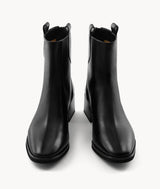 Front view of black lambskin ankle boots with an almond toe