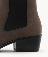 A detailed look at the sturdy block heel on these suede Chelsea boots, built for style and all-day comfort